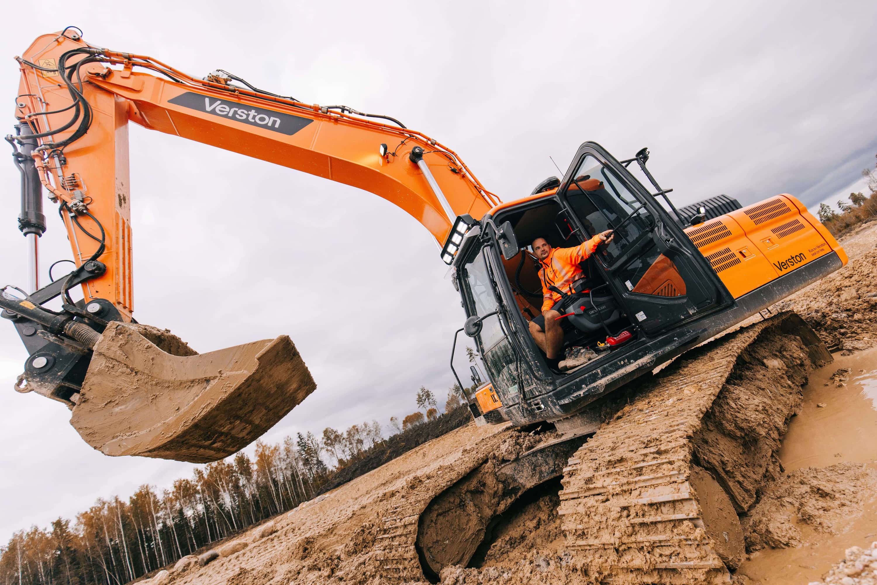 Verston excavator operator working on Rail Baltica construction site in Estonia, demonstrating cloud-connected machine control technology